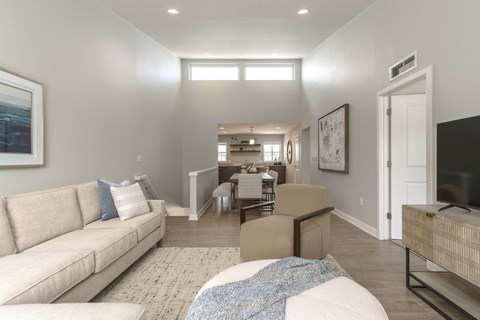 a living room and dining room with a couch and a tv